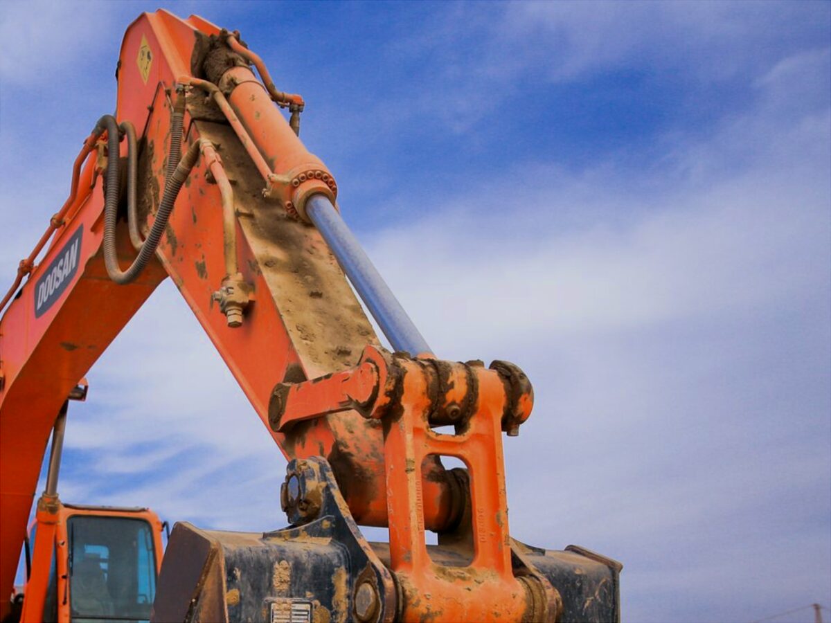 Hydraulic ram and hoses on an excavator boom