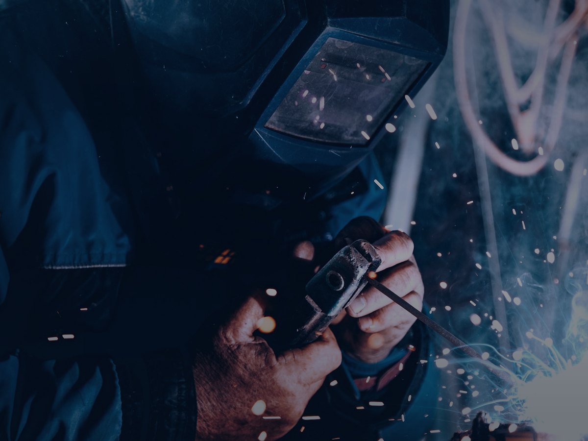 Welder working with a stick electrode and sparks